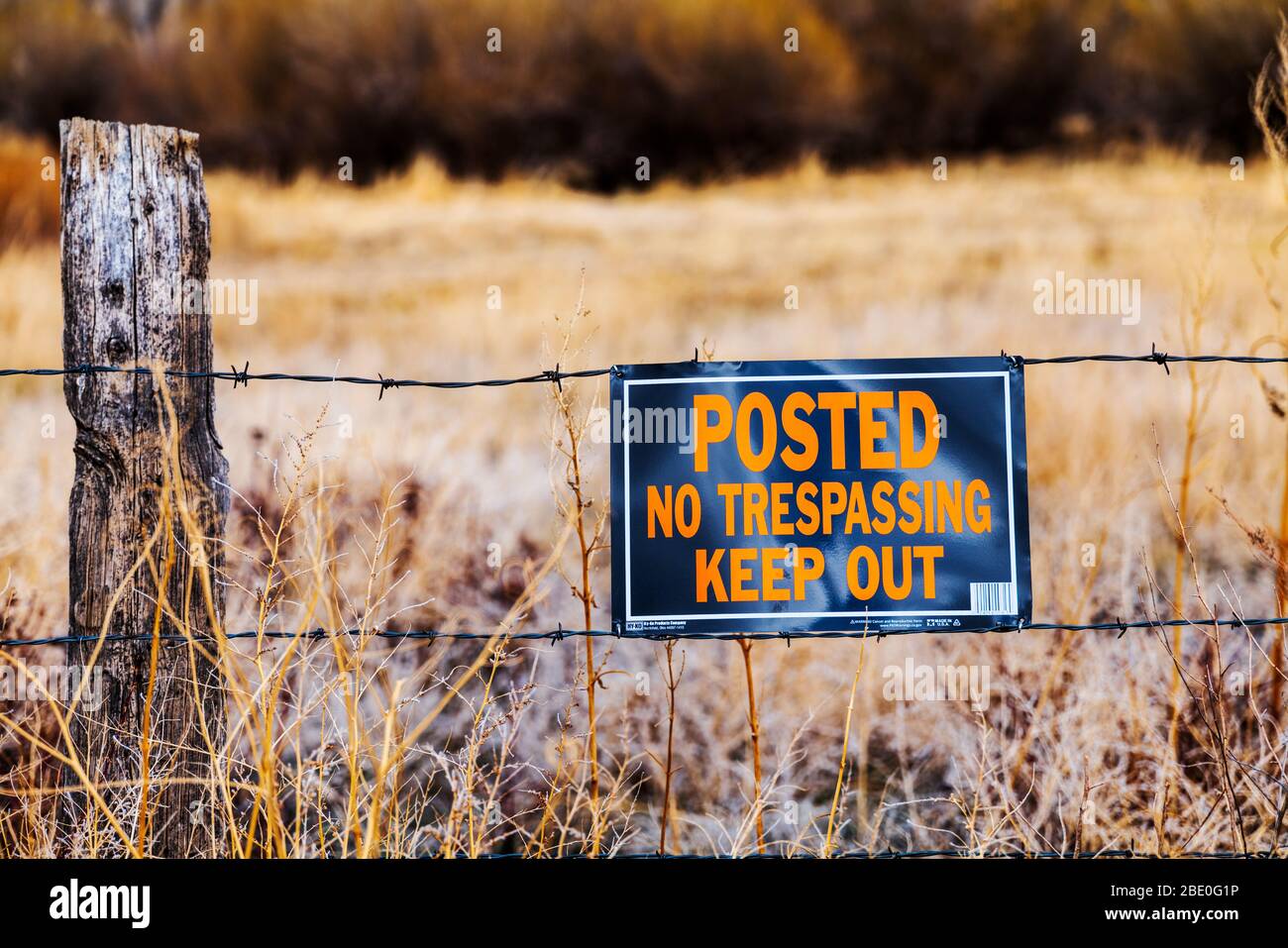 'Posted, No Trespassing, Keep Out' sign on central Colorado ranch fence Stock Photo