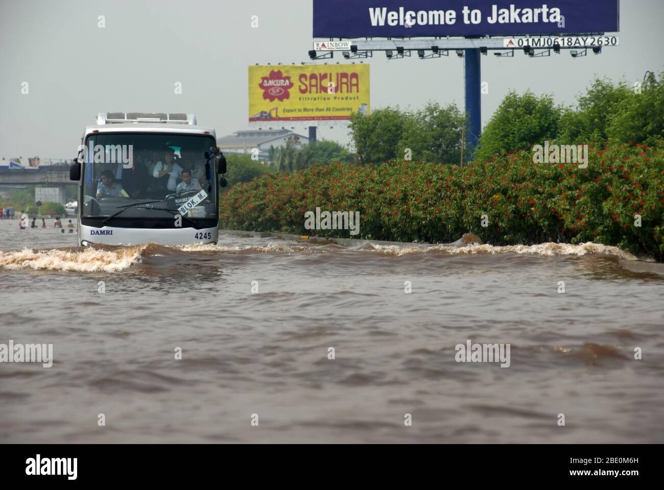 Jakarta Airport shuttle bus passing through flooded toll road in 2008. Archival Image. Photo: Reynold Sumayku Stock Photo