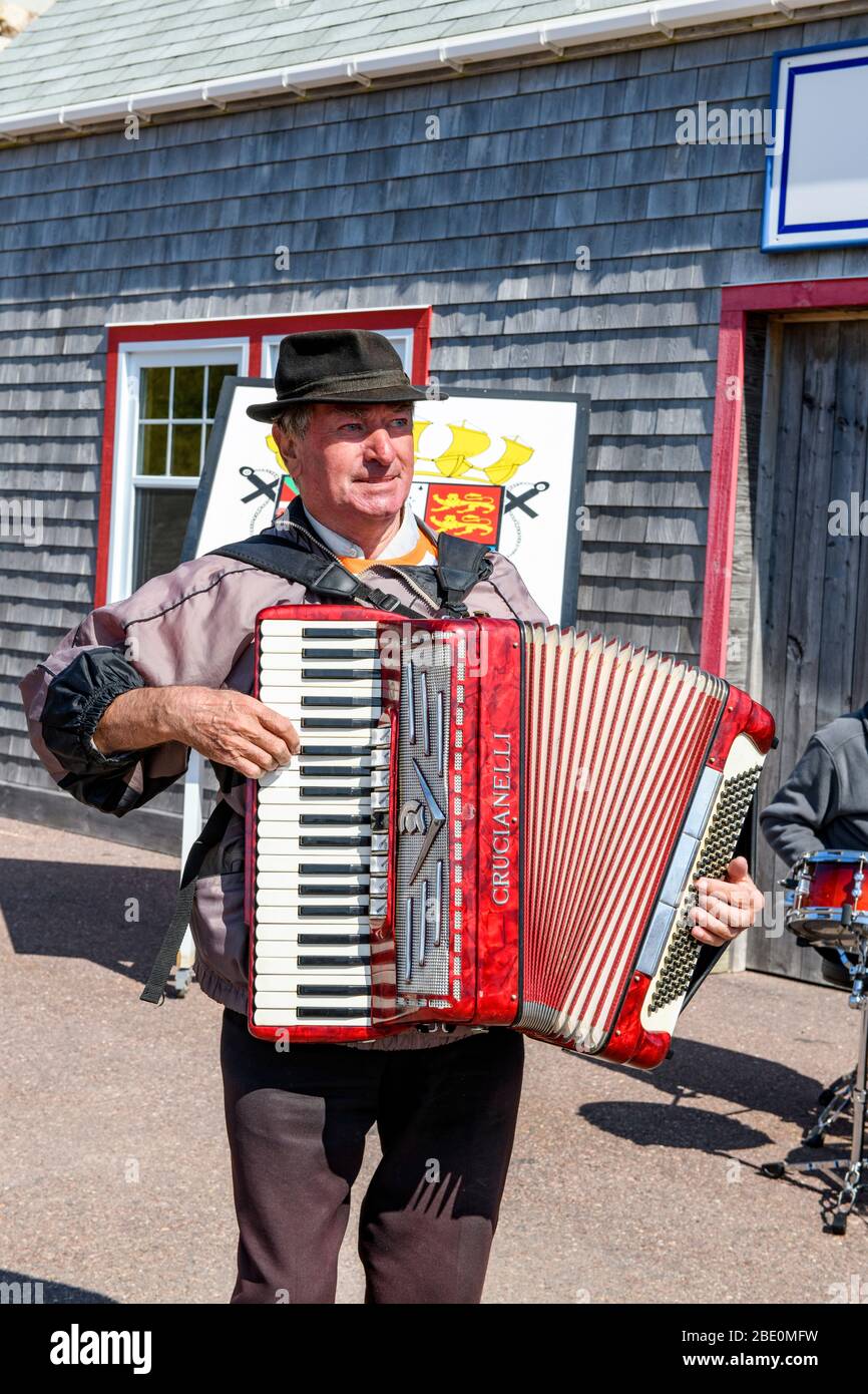 New France, France, St-PIerre et Miquelon. Musicians playing to greet the ship. Accordian player. Stock Photo