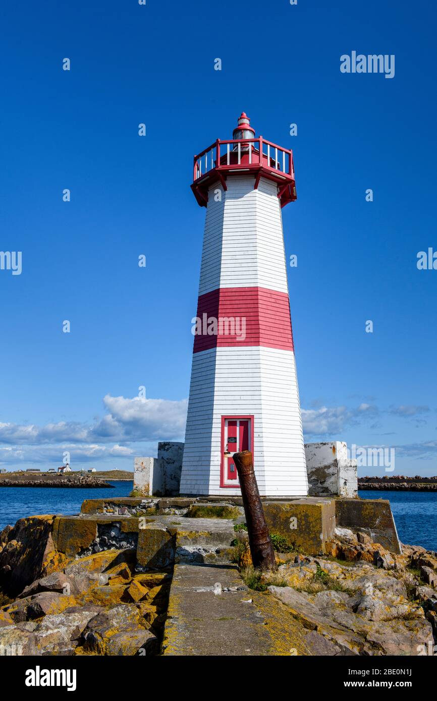New France, St-PIerre et Miquelon, Canadian Maritimes. Lighthouse in the harbor Stock Photo