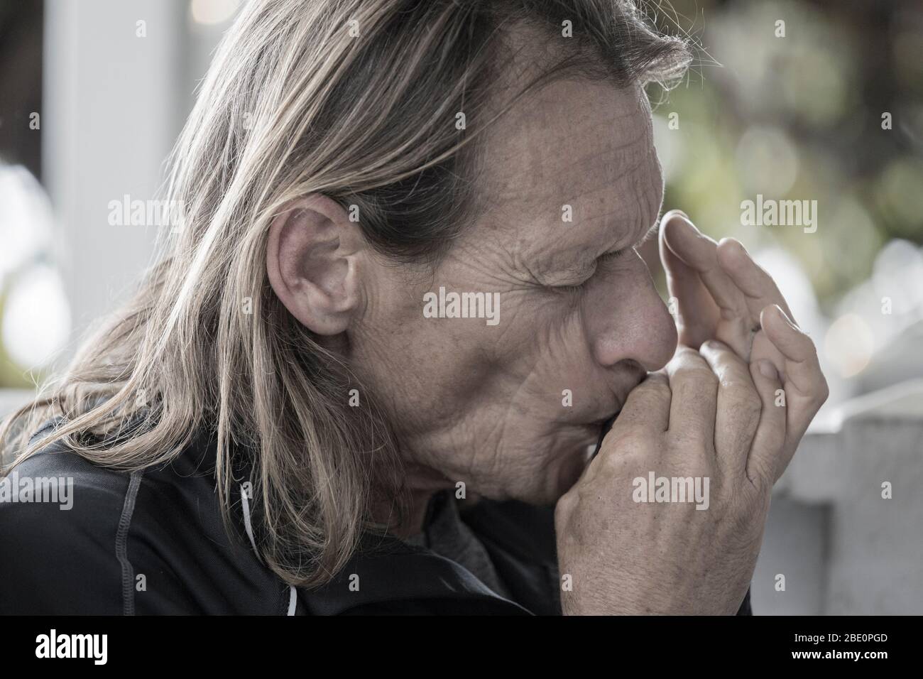 Musician (model released) jams on harmonica in Hawaiian kanikapila Stock Photo