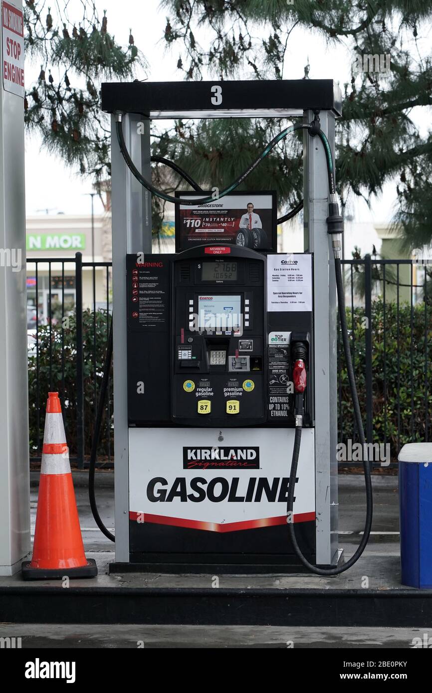 A reduced hours notice on a Kirkland gasoline pump at Costco Wholesale store amid the global