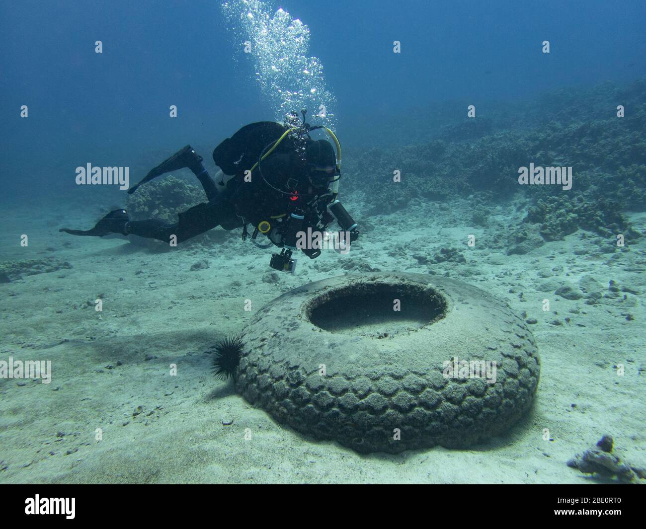 Scuba diver exploring underwater debris at Mahukona dive site on the
