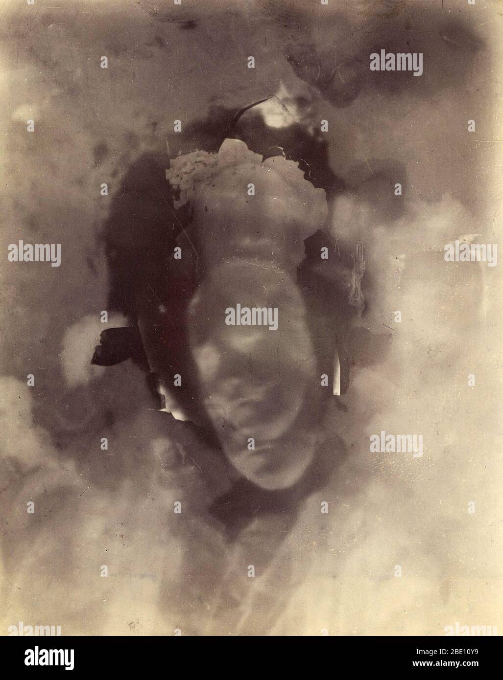 A 'Thoughtograph' or psychic photograph. Made by Charles Lacey, c. 1894-98. Albumen and gelatin silver print. A head and face can be seen in the center of this photograph, with a 'thought' emerging in a cloud above. Spirit photography became popular in the late 19th century, after some charlatans discovered that photo negatives could be doctored to show the 'hidden' element of life, including ghosts, thoughts, and souls. Stock Photo