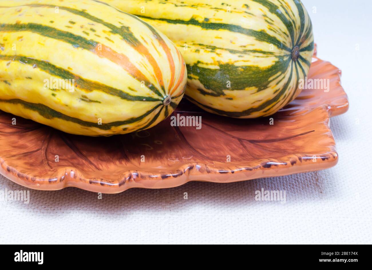 Two delicata squashes on a plate Stock Photo