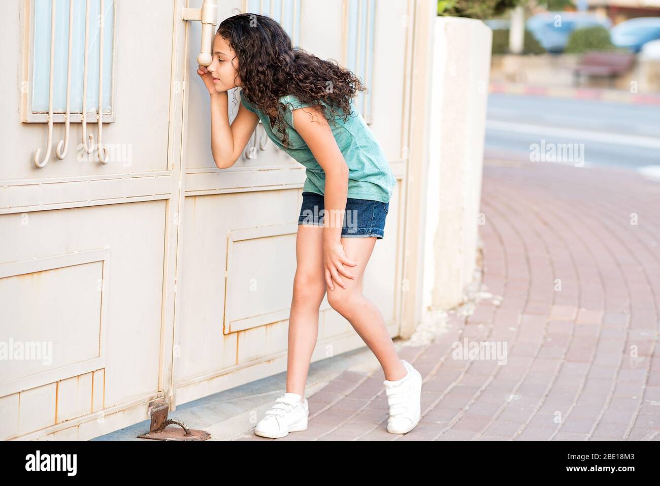Little Curly Hair Girl Peeping Through The Door Stock Photo Alamy