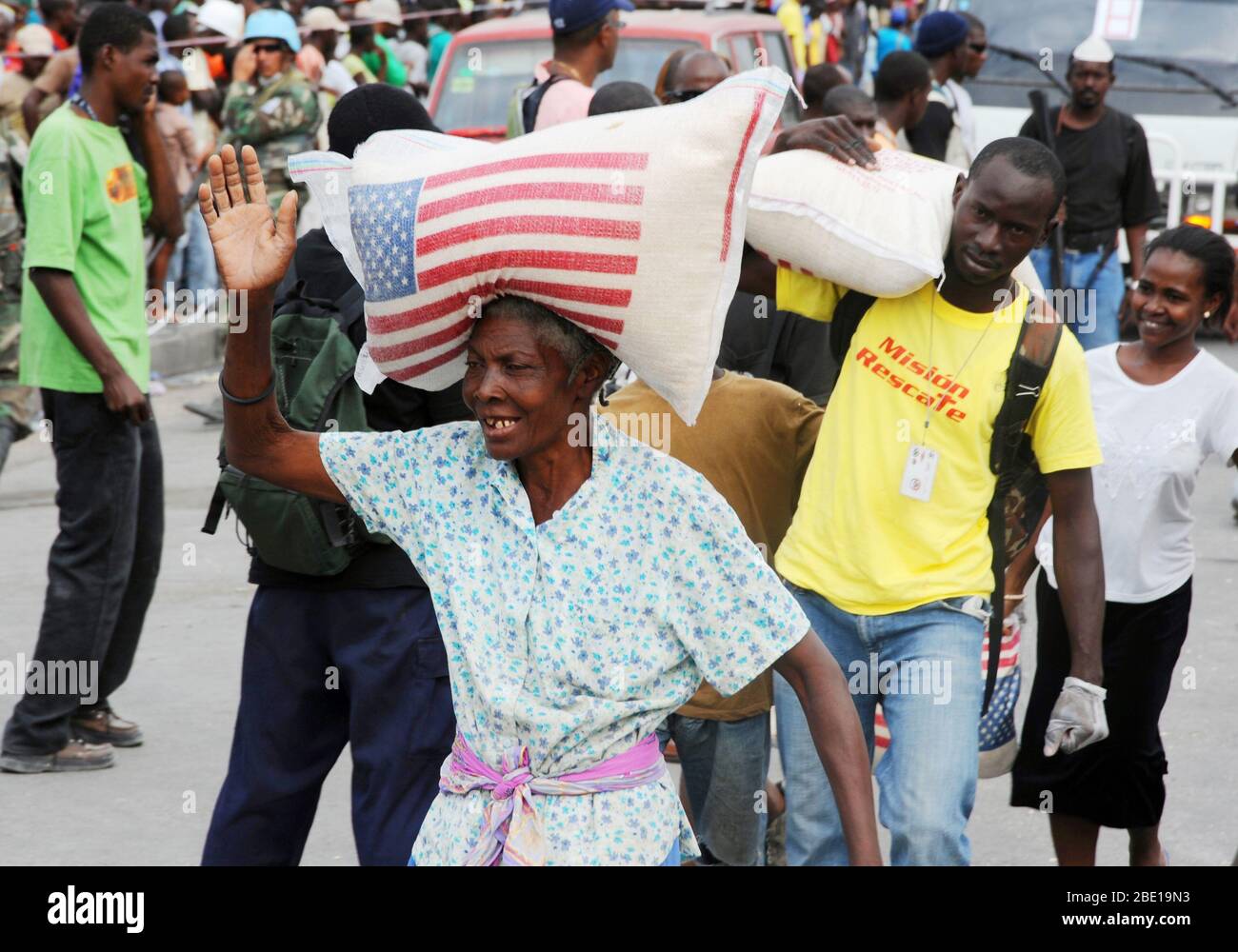 Haitians line up for bags of rice in front the Presidential Palace in Port au Prince, Haiti on