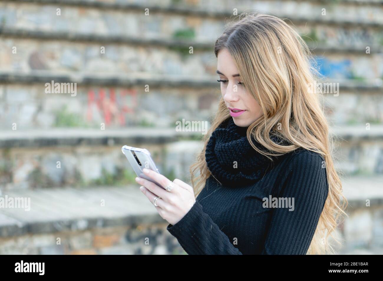 Close up of beautiful young millennial woman chatting and browsing social  media apps to connect with friends and family outdoors using her smartphone  Stock Photo - Alamy