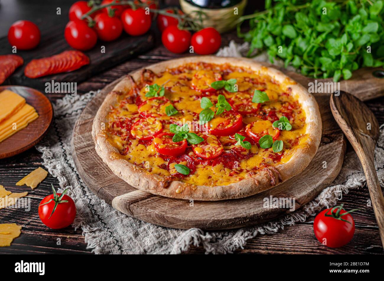 Rustic homemade pizza with sharp cheddar chesse and spicy salami Stock ...