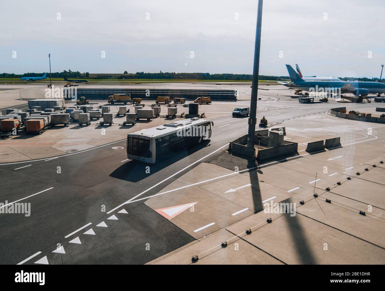 Apron area at the aerodrome with an airport bus, storage containers and  ground support vehicles Stock Photo - Alamy