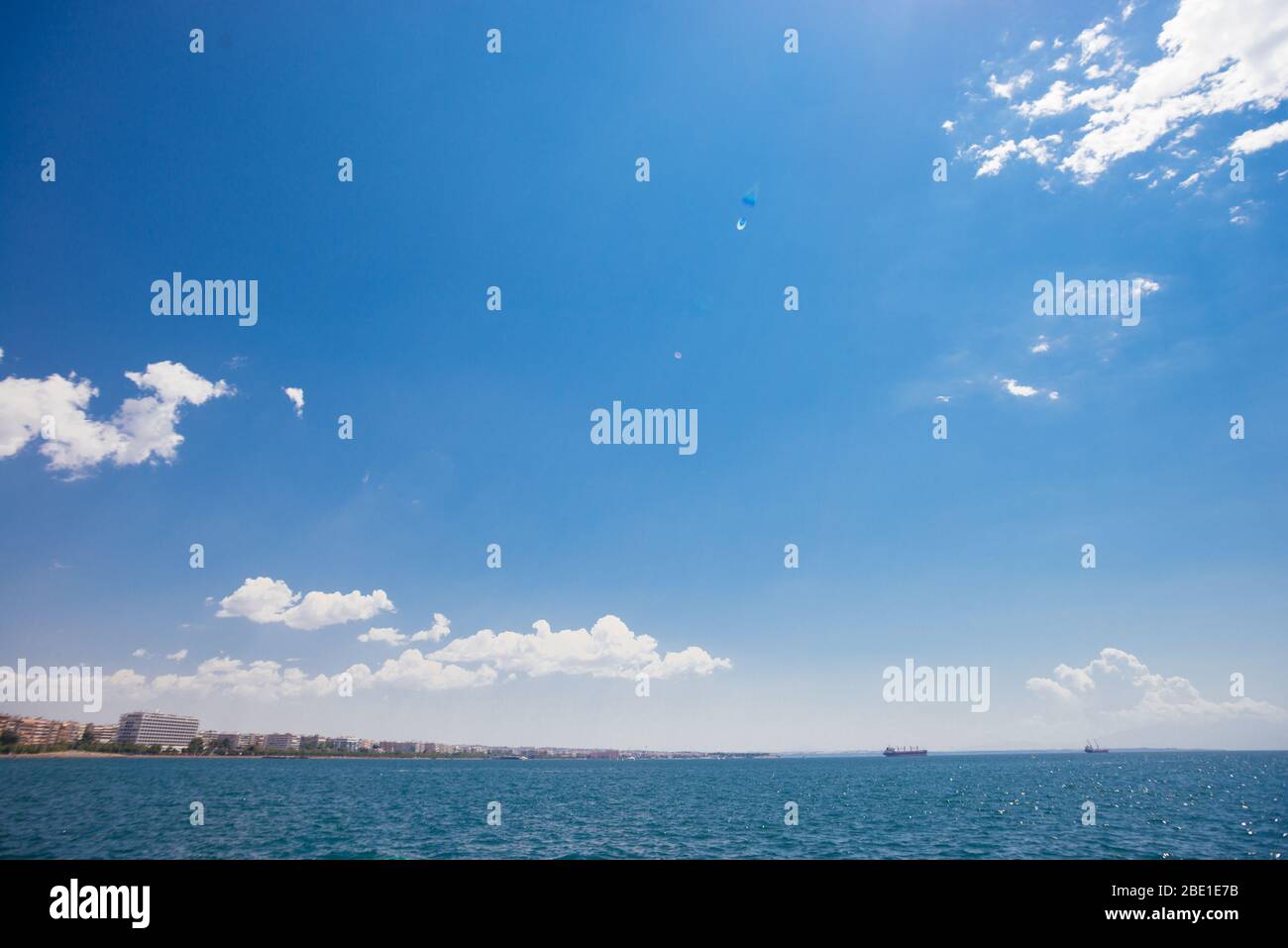 Seascape with sea horizon and almost clear bright blue sky Stock Photo ...