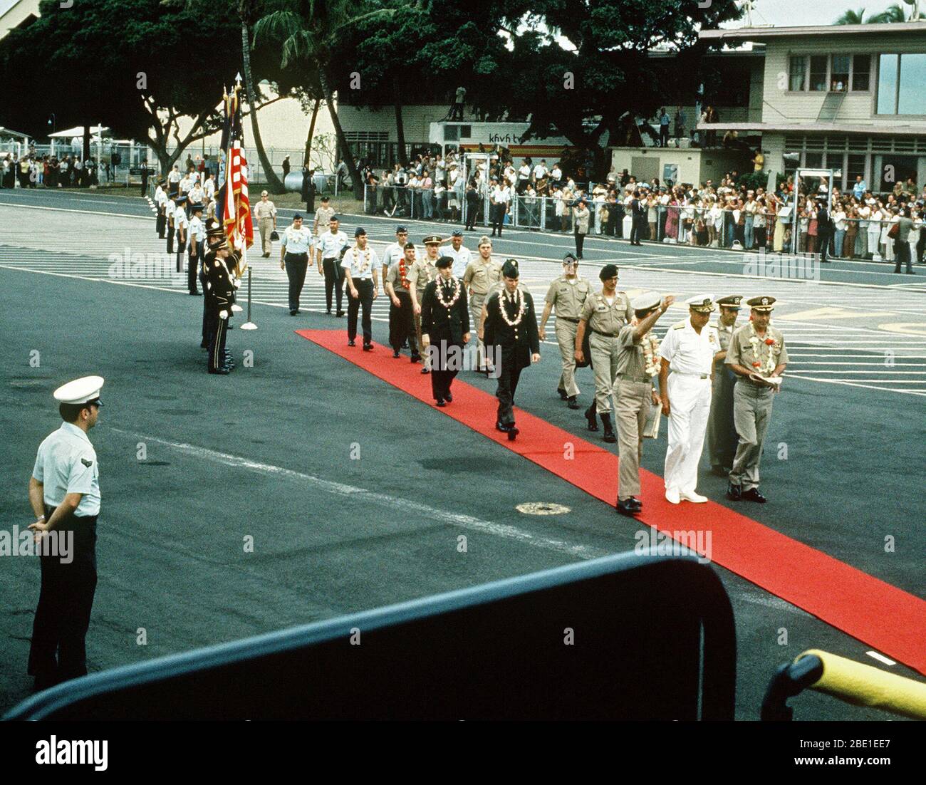After a brief refueling stop, the first group of Prisoners of War released in Hanoi by North Vietnam walk on the red carpet toward their waiting aircraft.  They are lead by Pacific Command's officials and POW, U.S. Navy CPT Jeremiah Andrew Denton, (Captured 18 Jul65).  The POWs were enroute from Clark Air Base, Philippines to Travis Air Force Base, CA and then to be reunited with their families in the states. Stock Photo