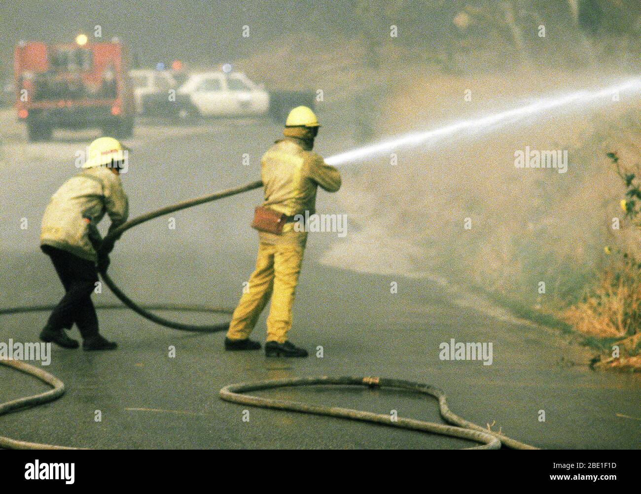 Firefighters battle fires in farmland during the four-day Panorama brush fire, which started in canyons north of town and has been whipped out of control by 40-50 mph winds. Stock Photo