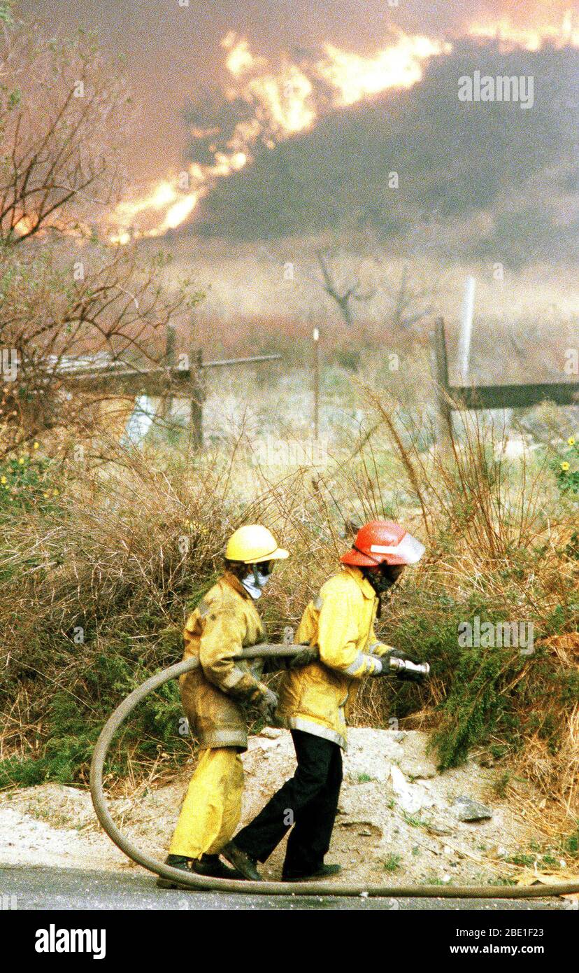 Firefighters battle fires in farmland during the four-day Panorama brush fire, which started in canyons north of town and has been whipped out of control by 40-50 mph winds. Stock Photo