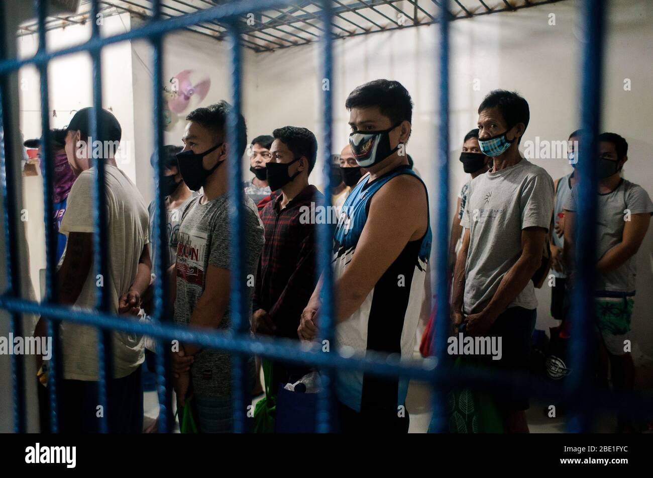 April 6, 2020 - Manila, Philippines: Detainees from Sitio San Roque, Quezon City await to be released on bail from Camp Karingal's detention center on April 6, 2020. Twenty-one residents were arrested for illegal assembly during an emergency health crisis during the enhanced community quarantine in Metro Manila to fight spread of COVID-19. On April 1, 2020, residents of Sitio San Roque gathered together to protest failings of the Duterte administration and local government to provide sufficient relief goods to their community. After a 15-minute warning, the Quezon City Police violently dispers Stock Photo