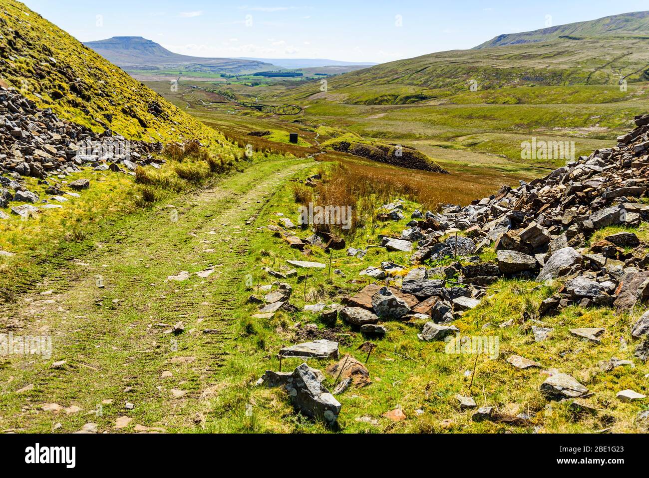 Track through outworks of railway tunnel on Blea Moor in the Yorkshire Dales, with Ingleborough behind Stock Photo