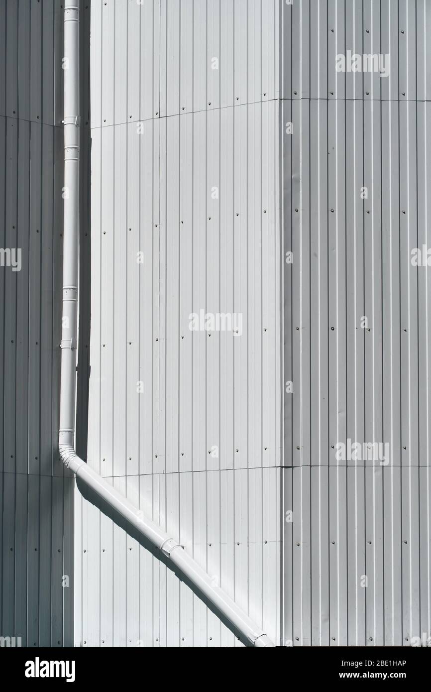 white metal siding on a wall and drain pipe as background Stock Photo ...