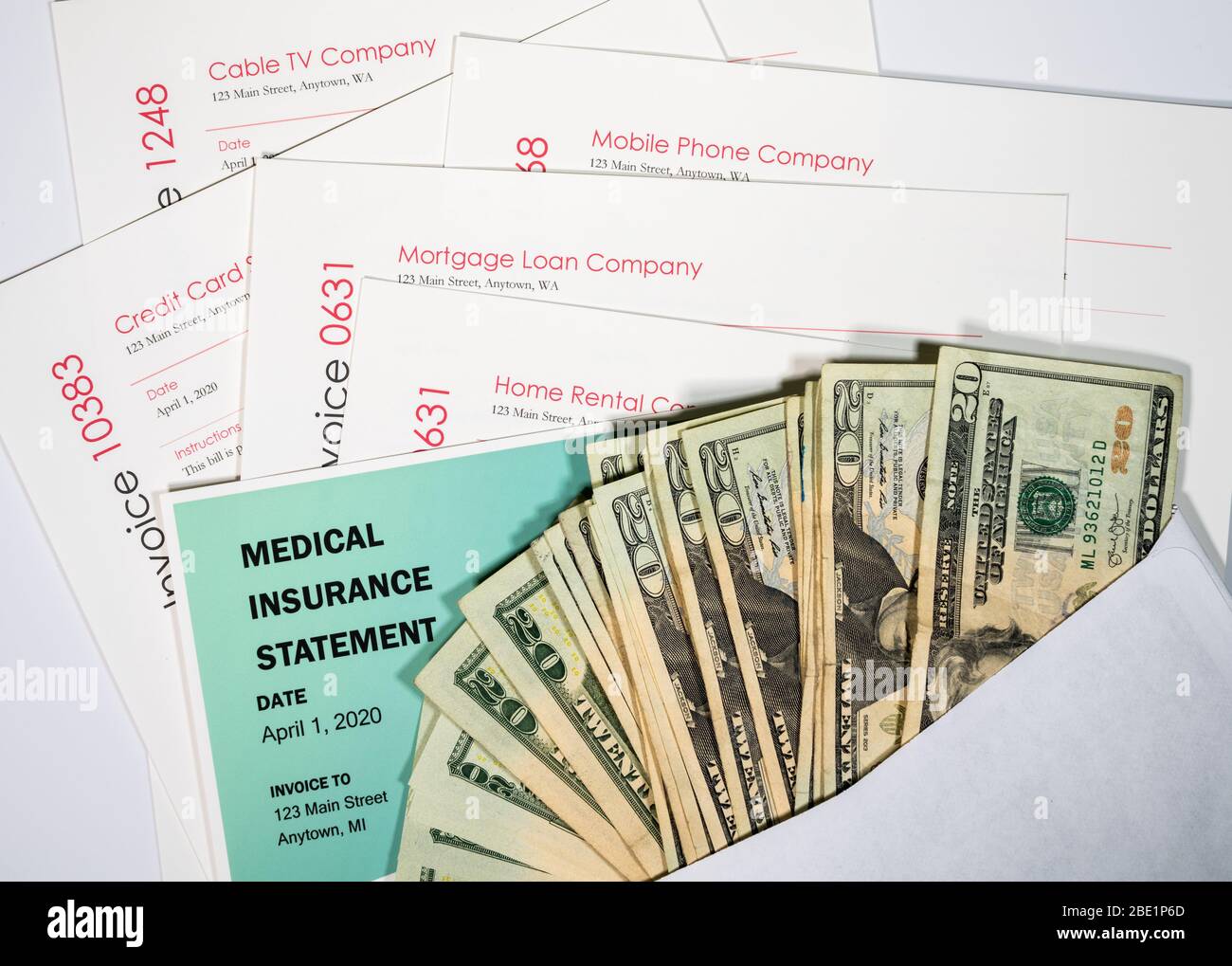 Stack of 20 dollar bills in envelope to illustrate coronavirus stimulus payment being used to pay many past due bills and invoices Stock Photo
