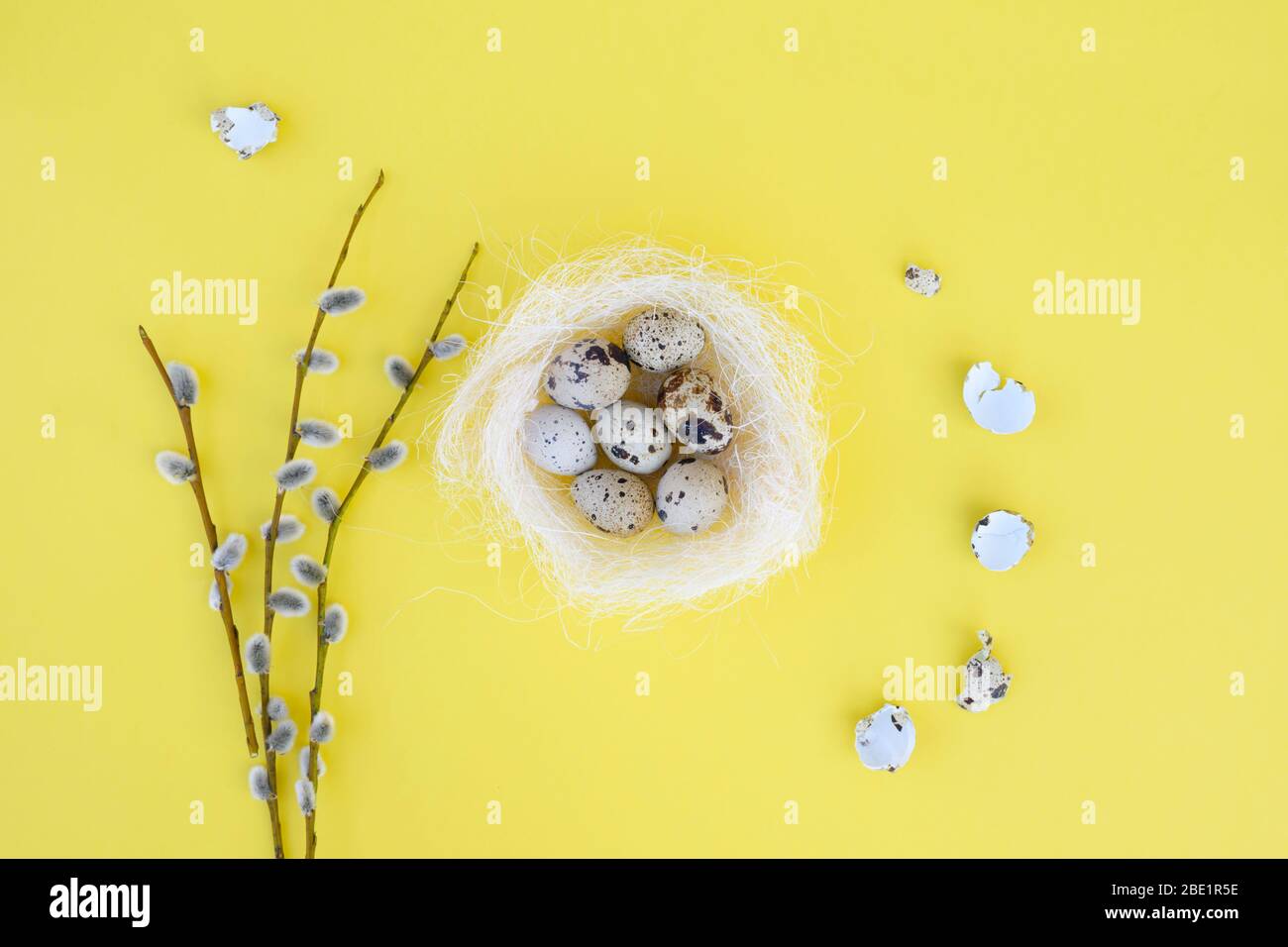 Decorative bird nest with many easter eggs on yellow background with ...