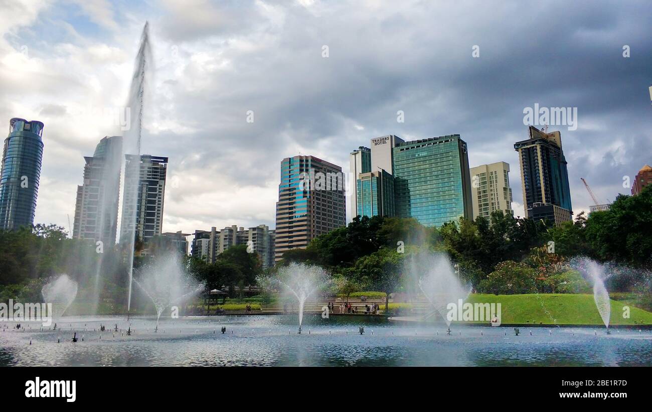Cityscape of Kuala Lumpur. Beautiful green central park with fountains ...