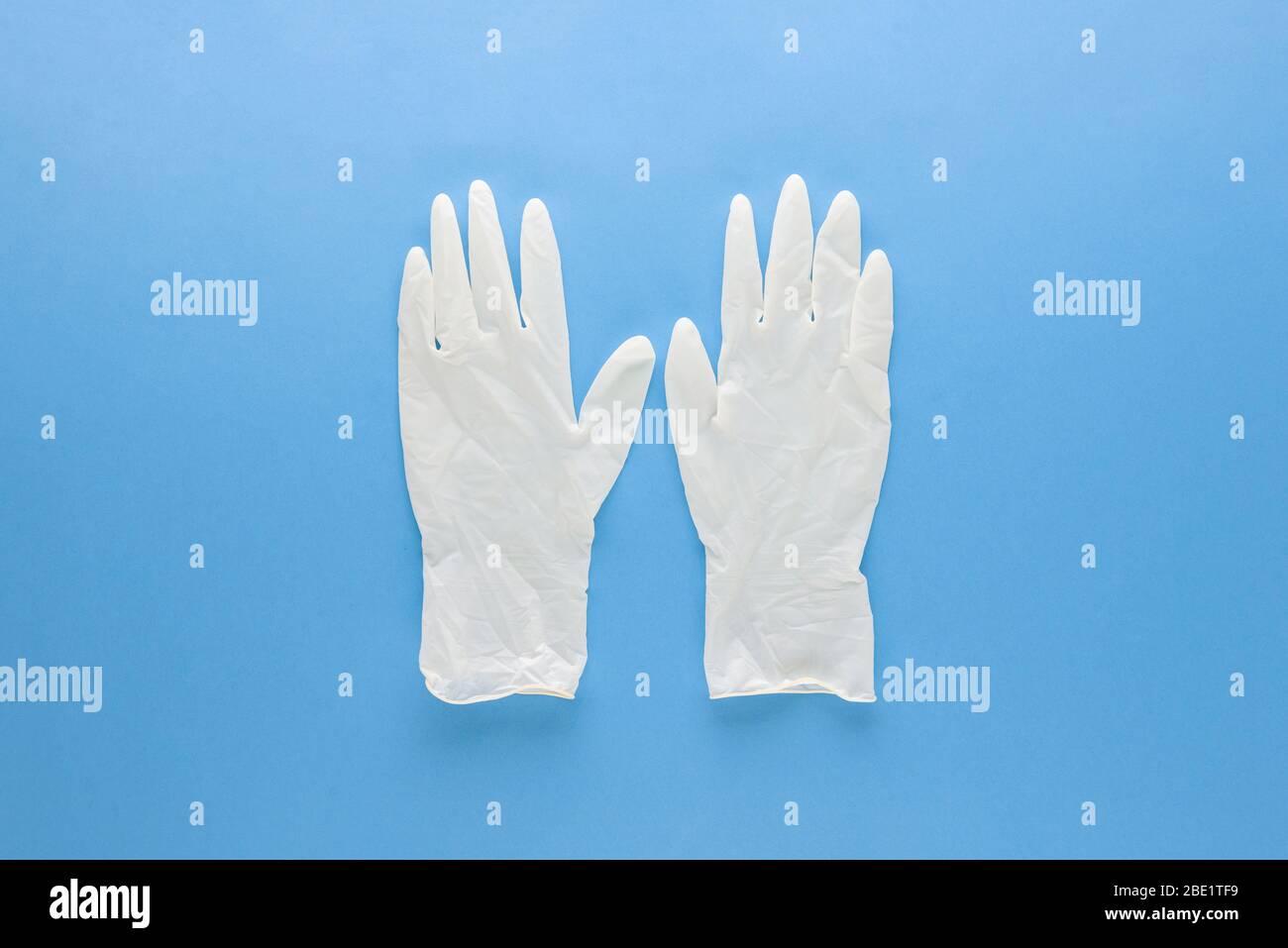New clean medical rubber gloves for protecting hands from germs isolated on light blue background Stock Photo