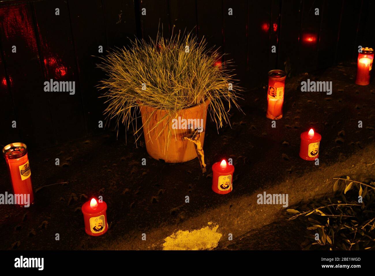 Wheat and candles in front of the churchyard on Good Friday. Quarantine prevents any other form of religious faith from being celebrated Stock Photo