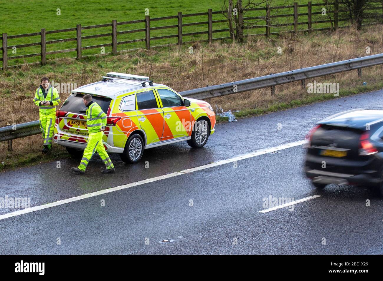 Highway Maintenance van parked on M6 motorway hard shoulder lane; vehicular traffic, transport, modern vehicles, cars, vehicle with hazard warning lights, high speed roads repair, motors, motoring occupations, UK Stock Photo