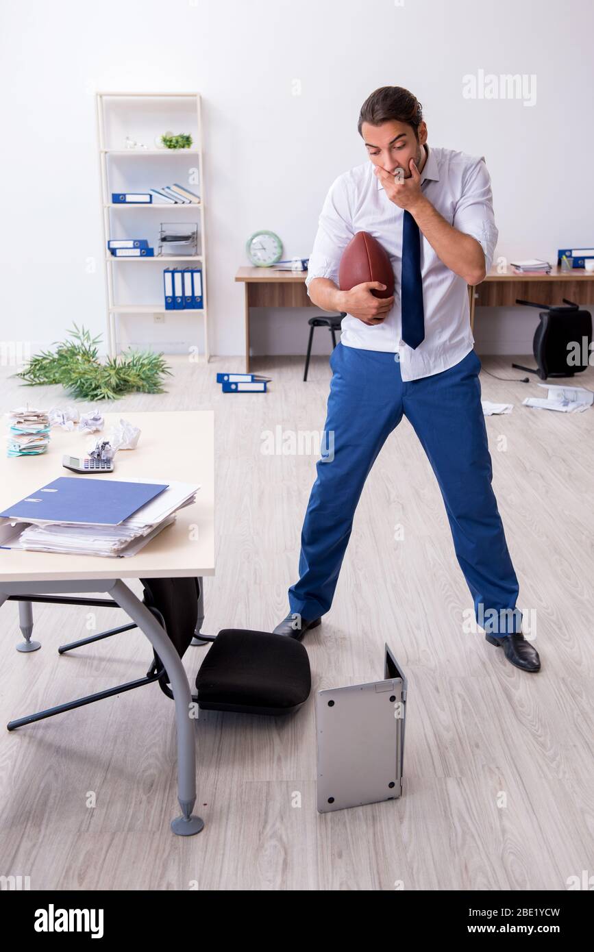 Young employee throwing rugby ball in the office Stock Photo Alamy