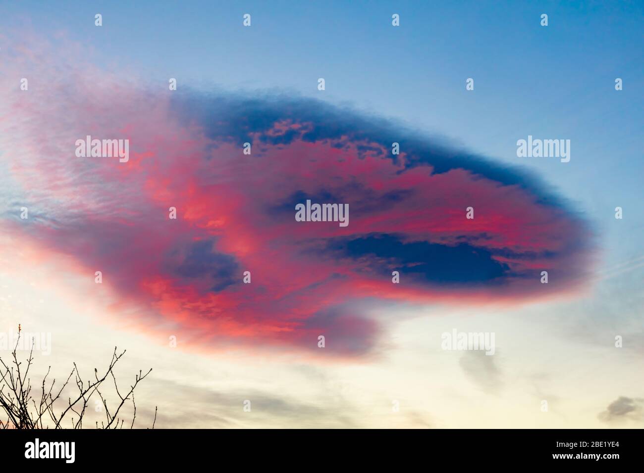 Spectaular lenticular cloud formation against a red sky  looks like UFO, Helensburgh, Scotland,UK Stock Photo