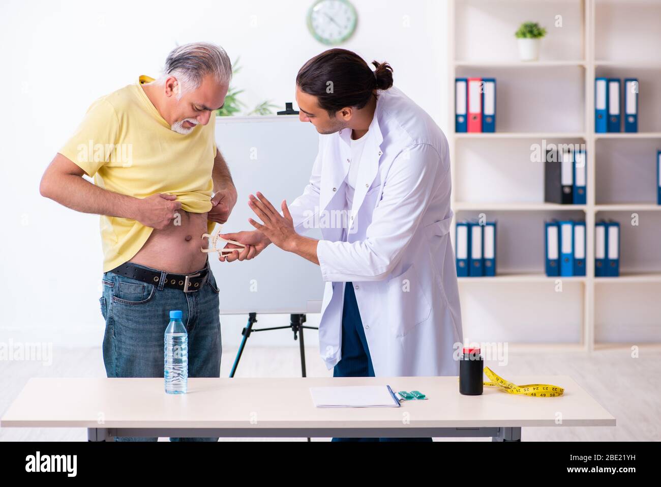 The doctor dietician giving advices to fat overweight patient Stock