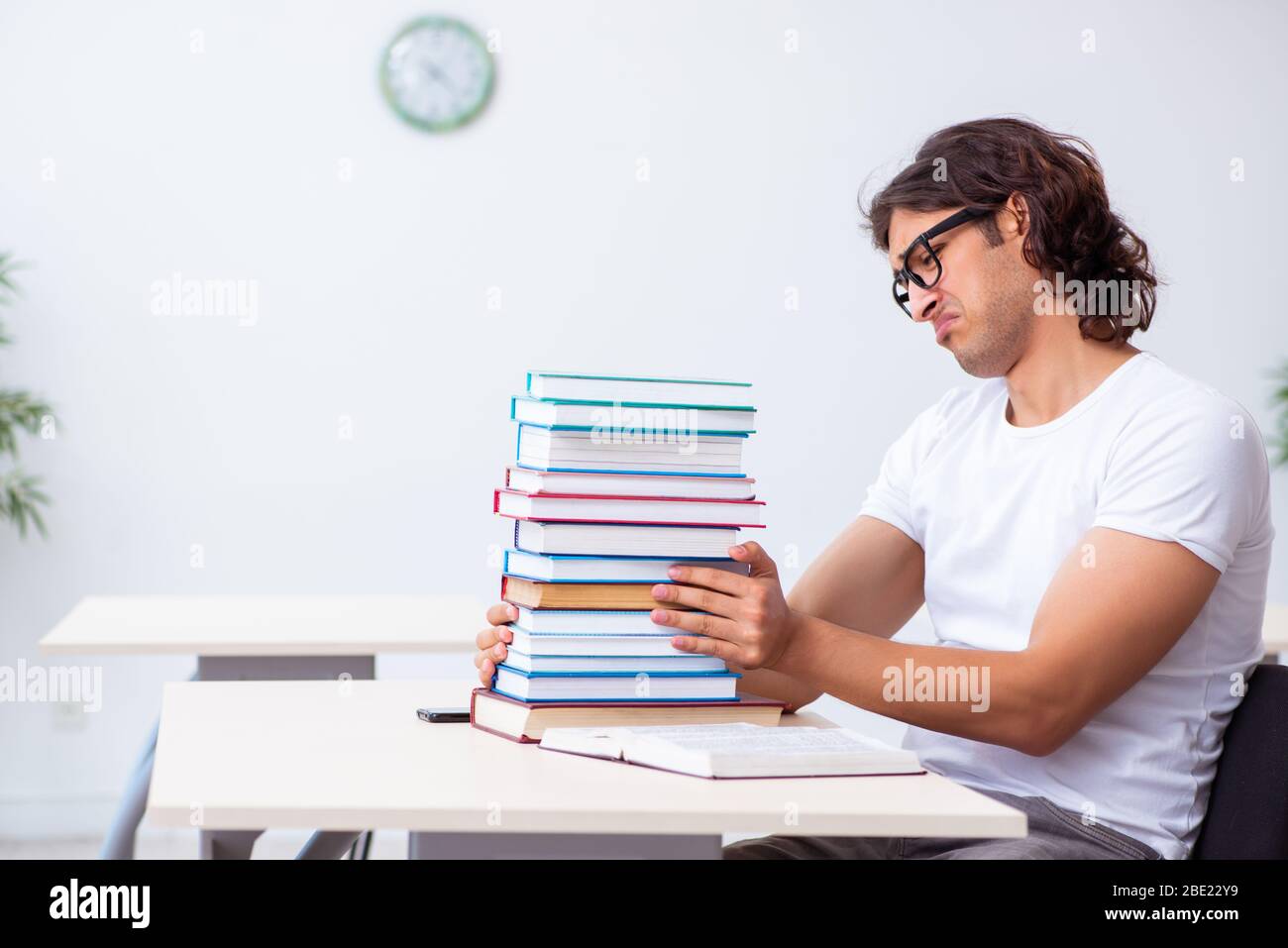 The young male student sitting in the classroom Stock Photo - Alamy