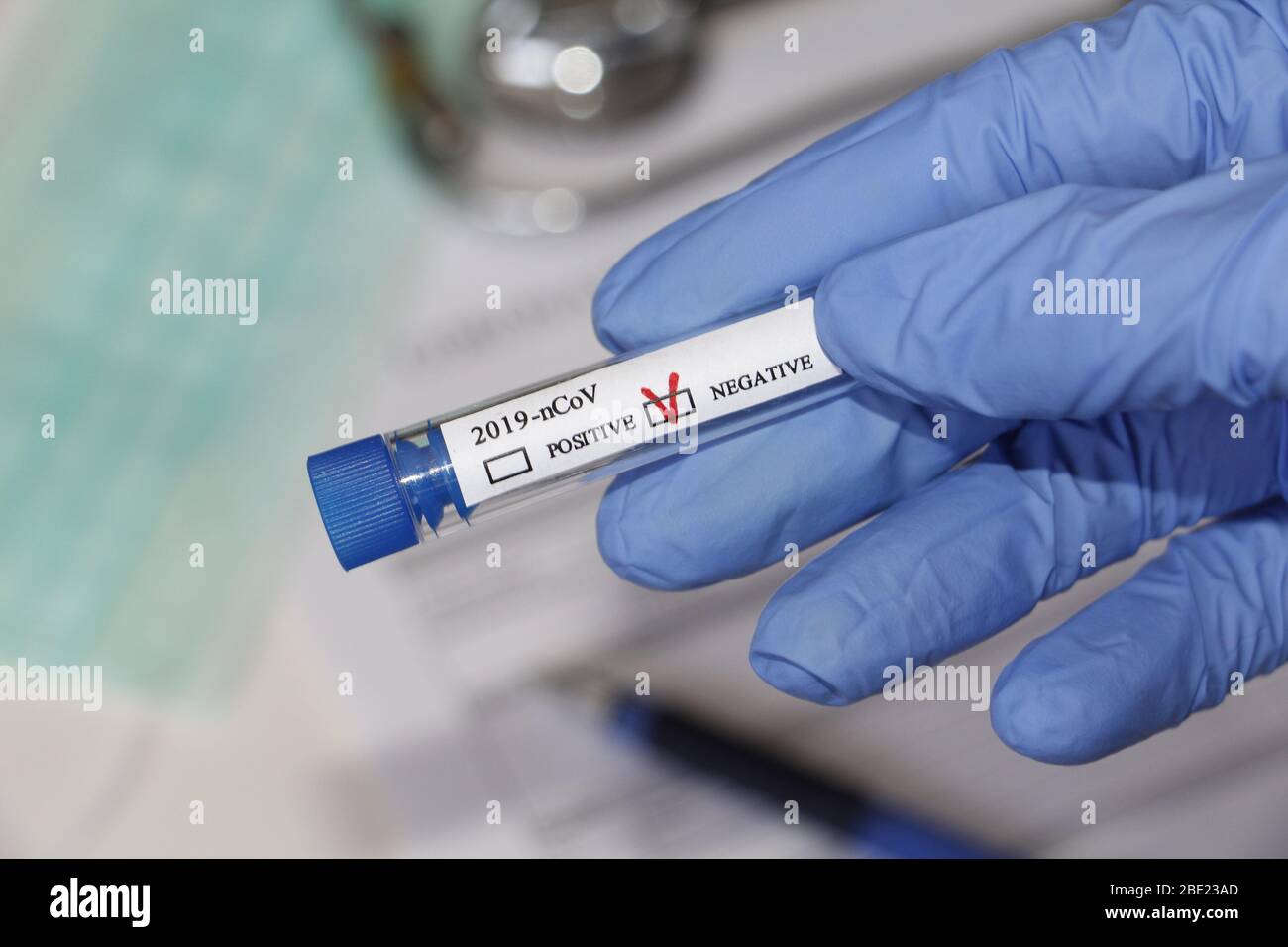 Conceptual photography - testing for coronavirus. In the hand is a test tube with a sample of the patient. The result of the analysis is NEGATIVE. Tas Stock Photo