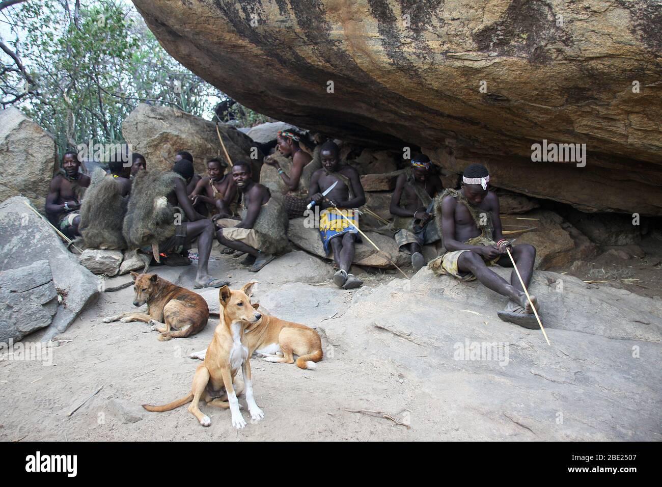 Hadza men prepare arrows before a hunting expedition Photographed at Lake Eyasi, Tanzania Stock Photo