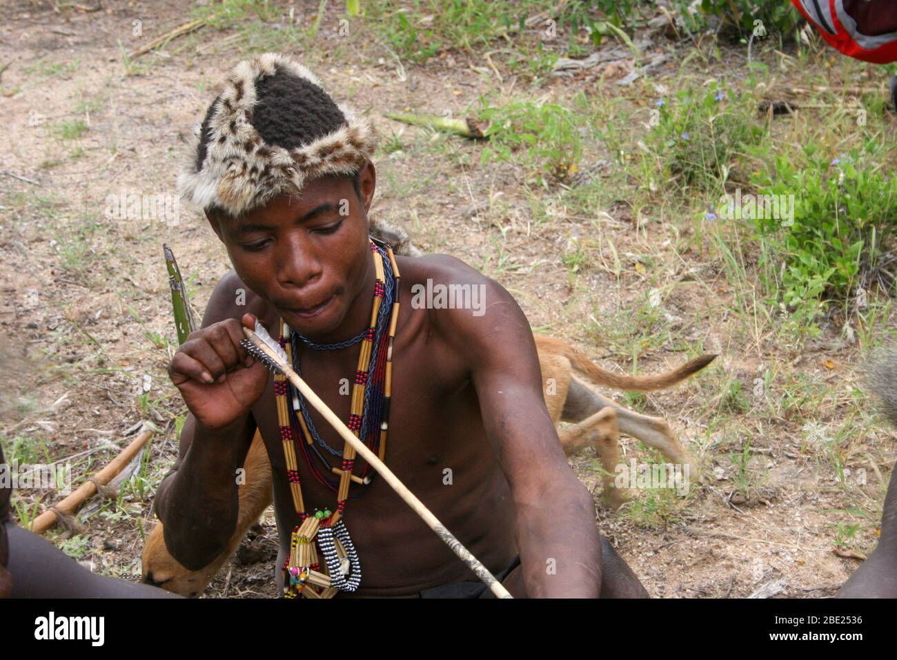 Hadza men prepare arrows before a hunting expedition Photographed at Lake Eyasi, Tanzania Stock Photo