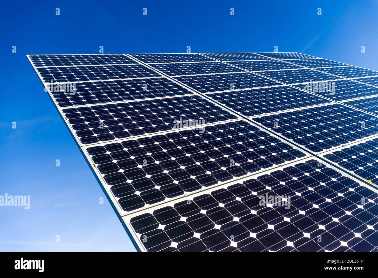 Close-up, detail view of solar panels of a solar power plant in cloudless and bright blue sky Stock Photo