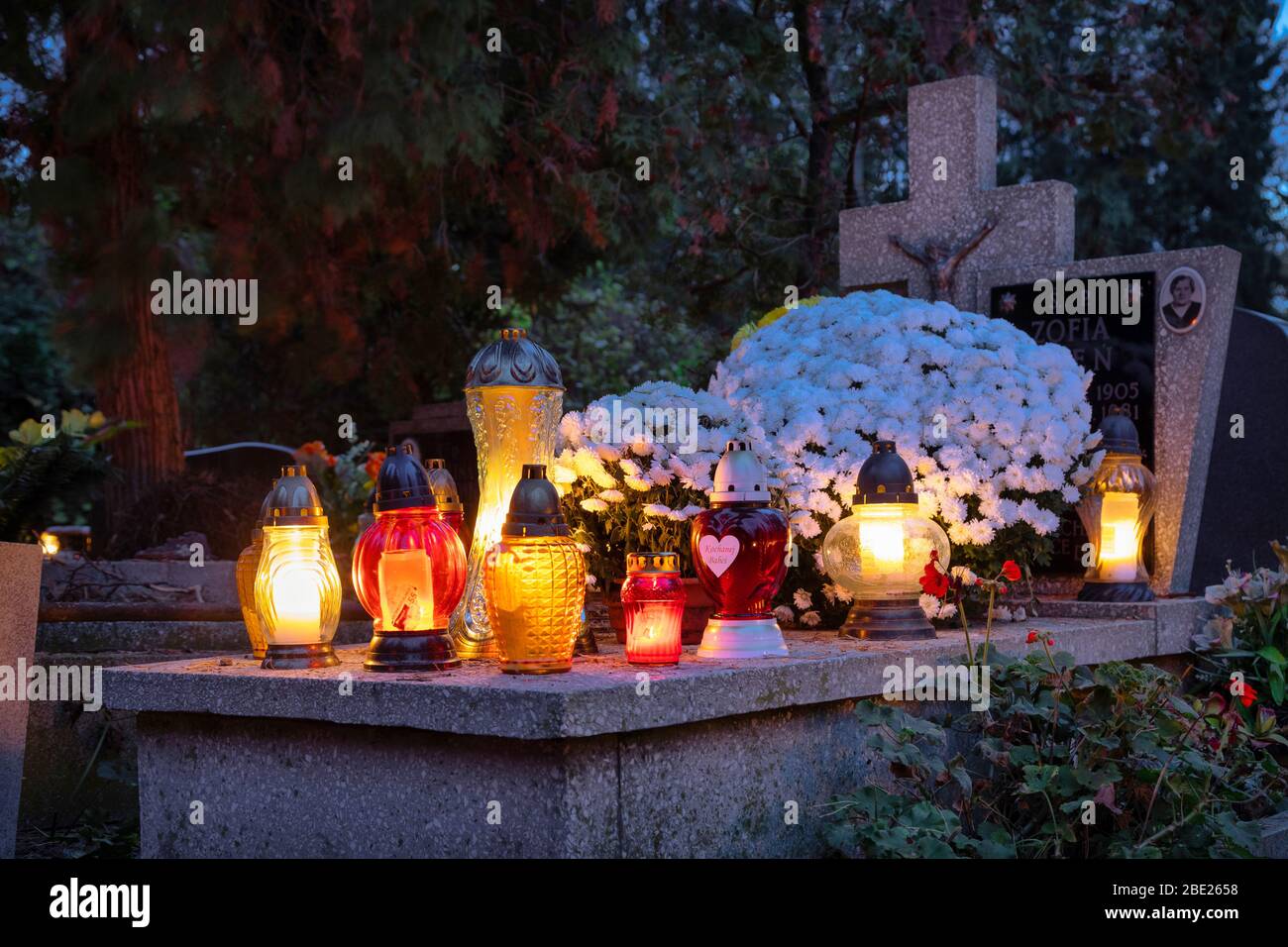 Wroclaw, Poland - 02 November 2019: Candles and lanterns on the grave devoted to All Souls Day - Christian holiday of remembrance for the souls of tho Stock Photo
