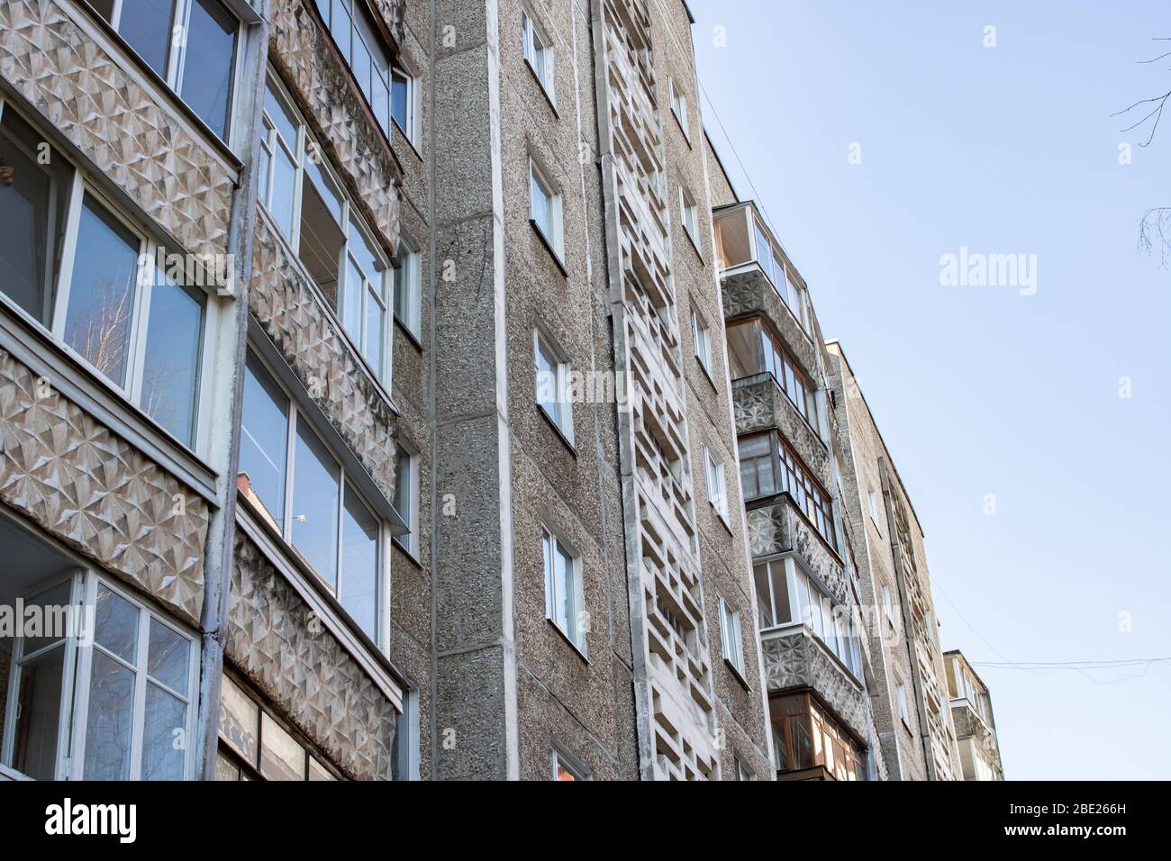 Windows of tall house on background of blue sky Stock Photo - Alamy