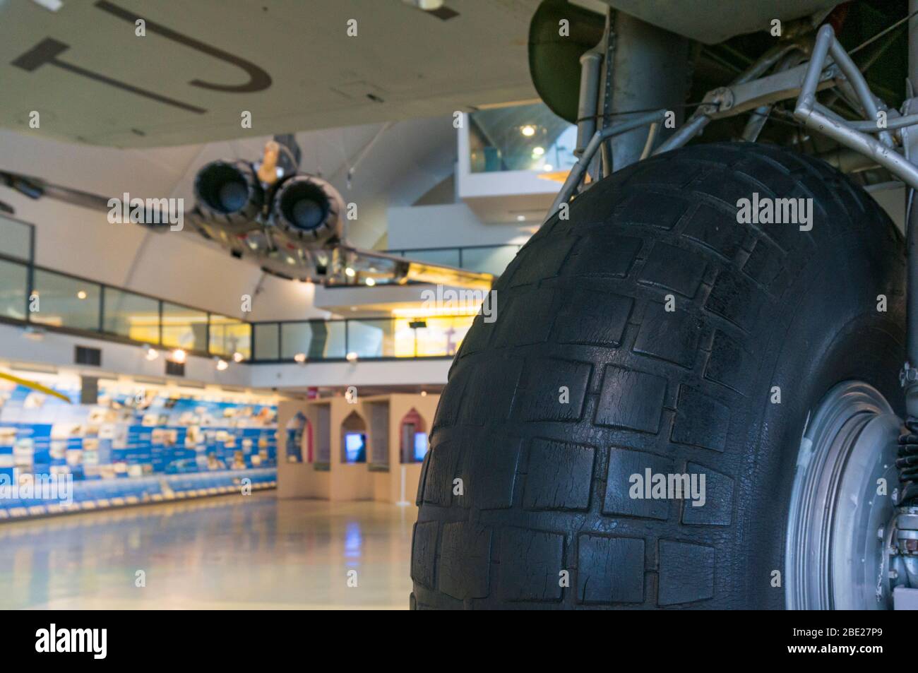 Abstract view of a De Havilland Mosquito wheel with a Eurofighter Typhoon suspended above in the background at the RAF Museum Hendon Stock Photo
