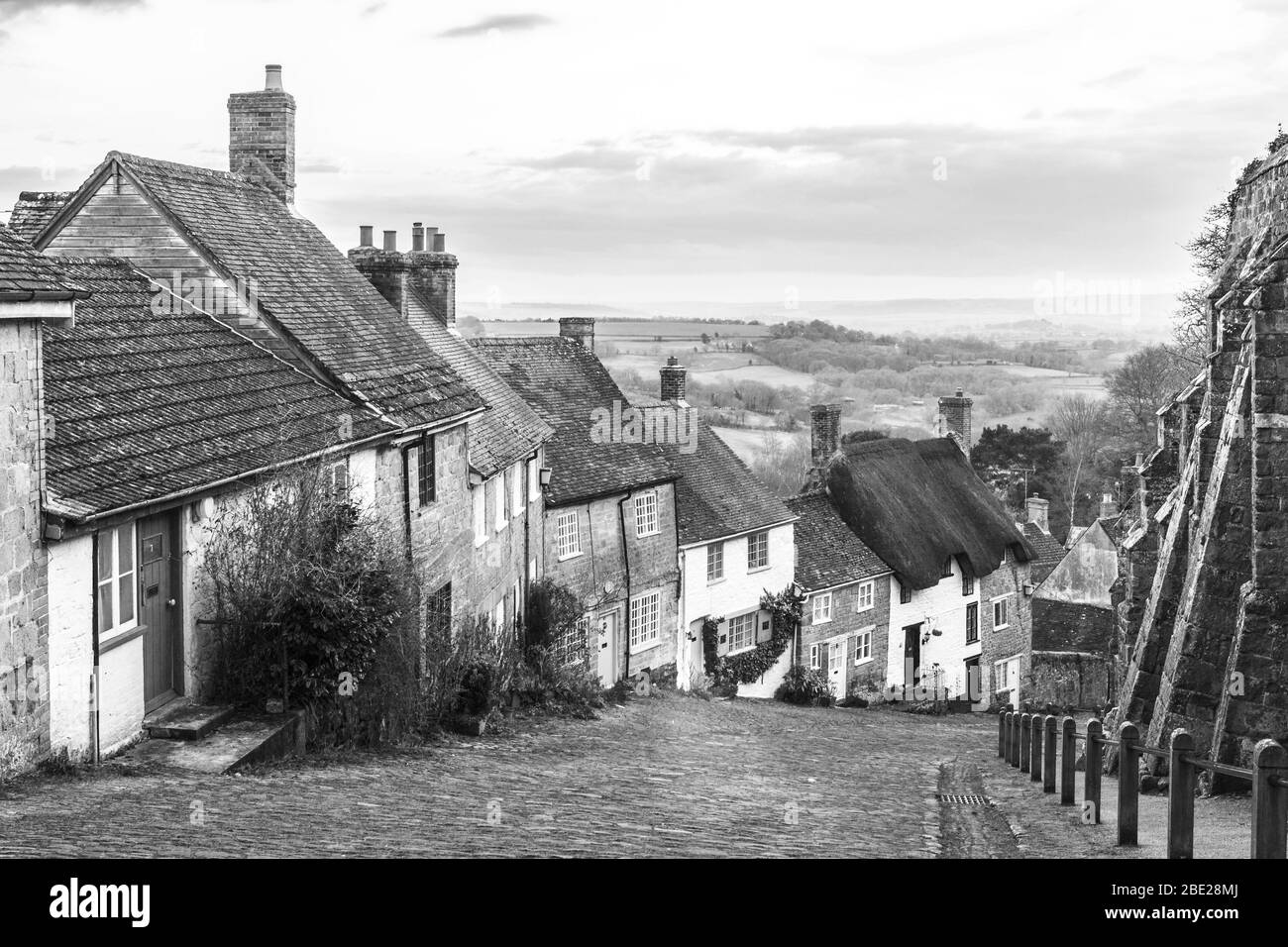 Gold Hill, Shaftesbury, UK, Black and White image of the steep hill and cobbled street with pretty cottages in a timeless image Stock Photo