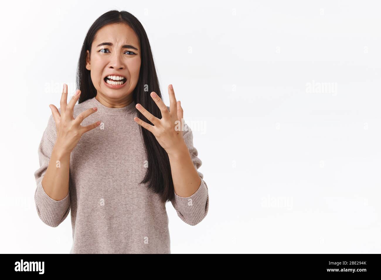 Freak-out outraged and overreacting east-asian girl in panic, gesturing betrayed and anger, raging in fury, having mental breakdown, lost someone Stock Photo