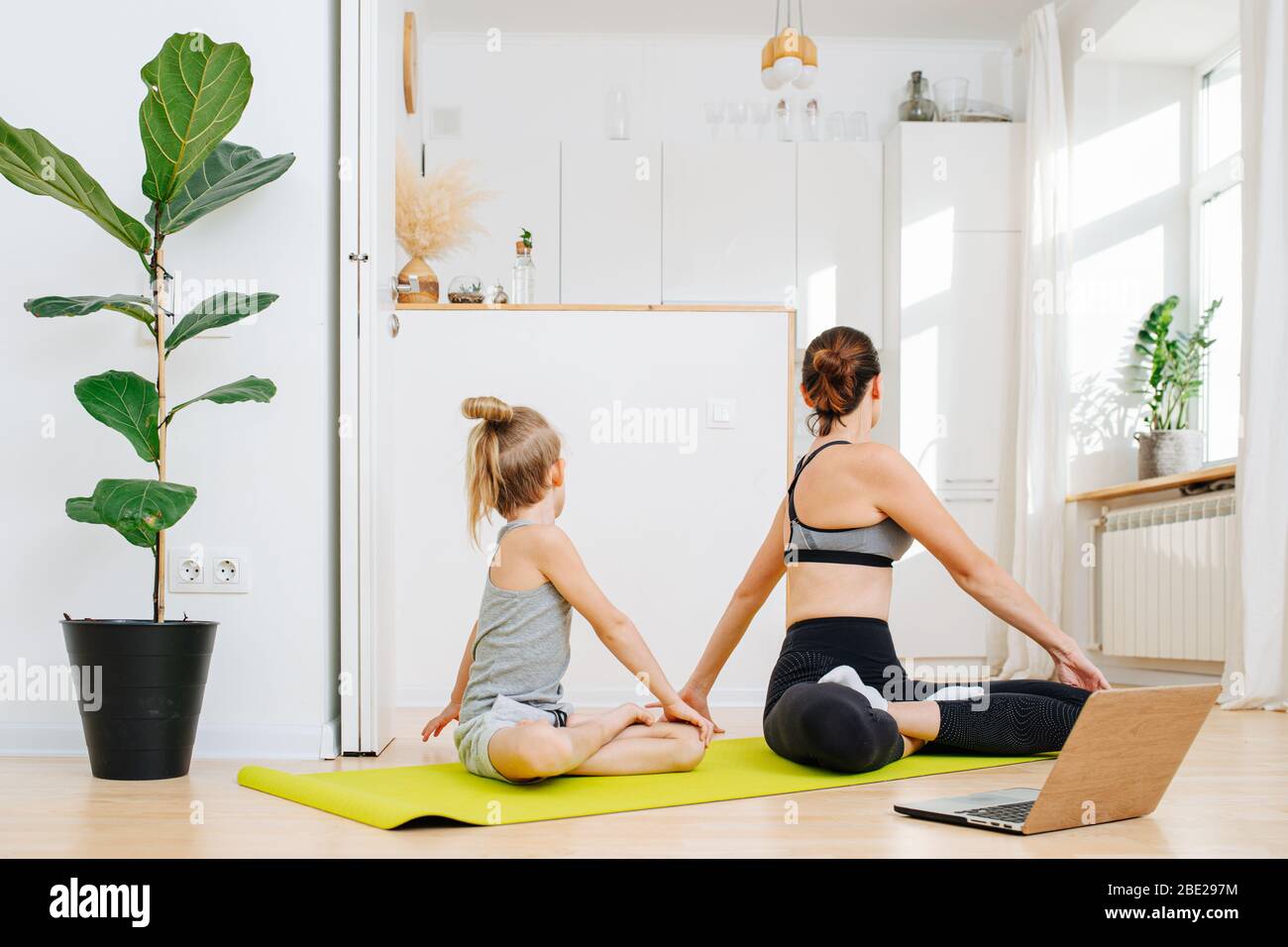 Mother and son are doing online yoga lesson at home Stock Photo Alamy