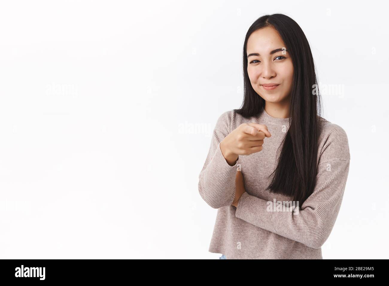Employment, corporate promo and youth concept. Cheerful sassy and confident asian woman making choice, picking you, pointing camera and smile pleased Stock Photo