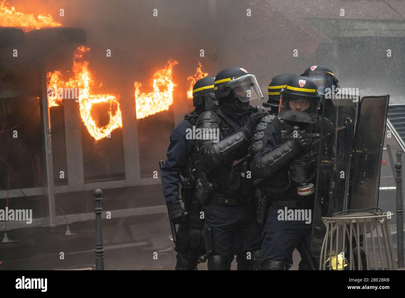 Police come under a barrage thrown by protestors during the Paris General Strike Stock Photo