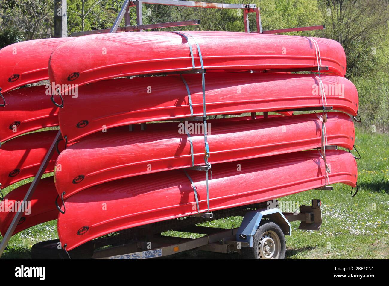 Red canoes stacked on a trailer Stock Photo