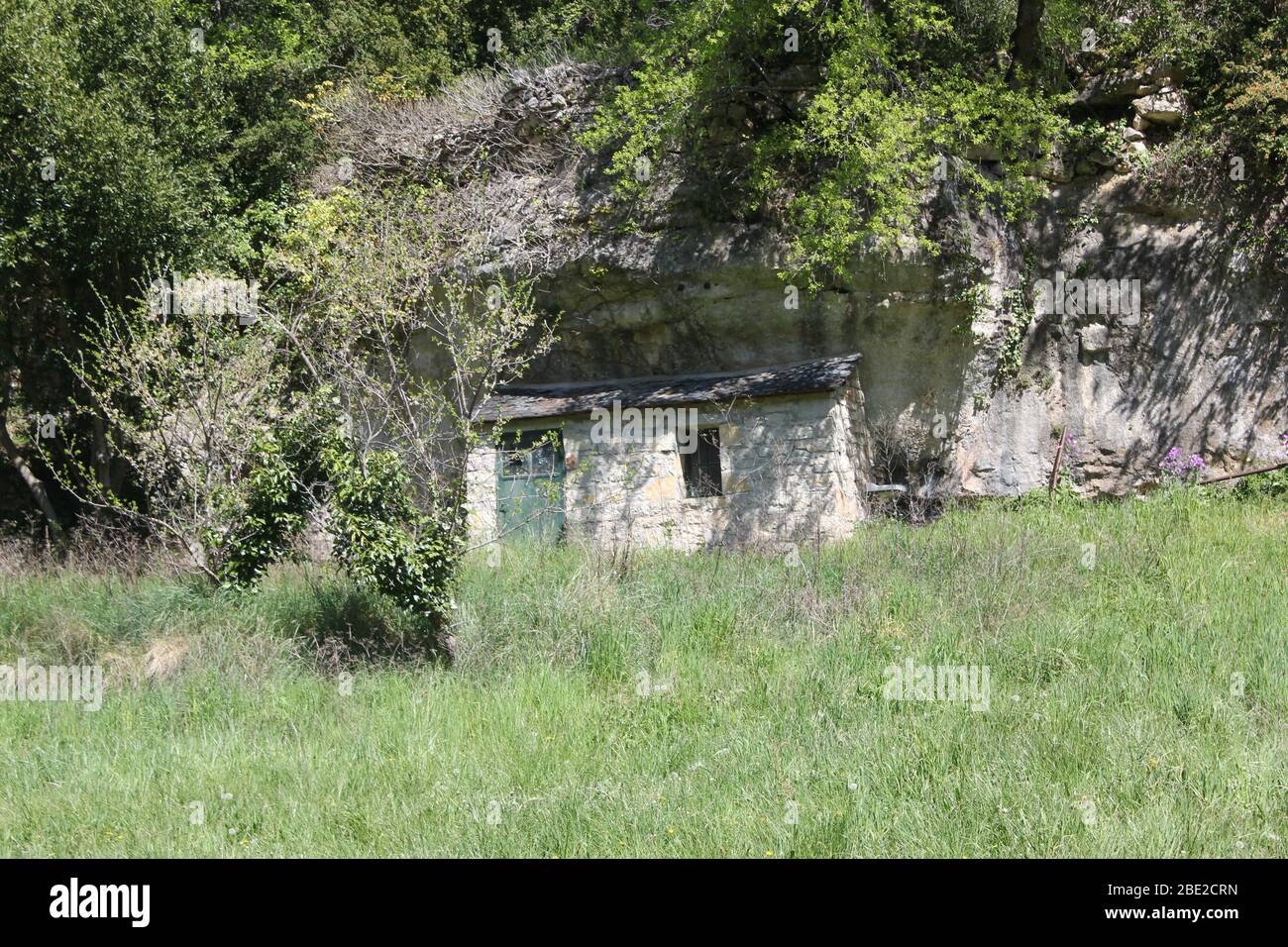 Cabin built into a rock face Stock Photo