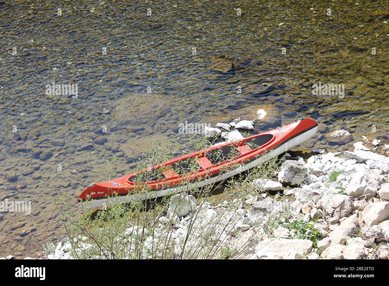 Red canoe, beached Stock Photo