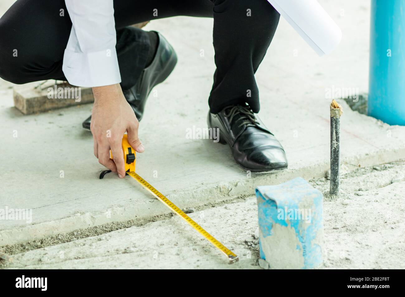 Inspector use measuring tape to check width measurement of drain in building Stock Photo