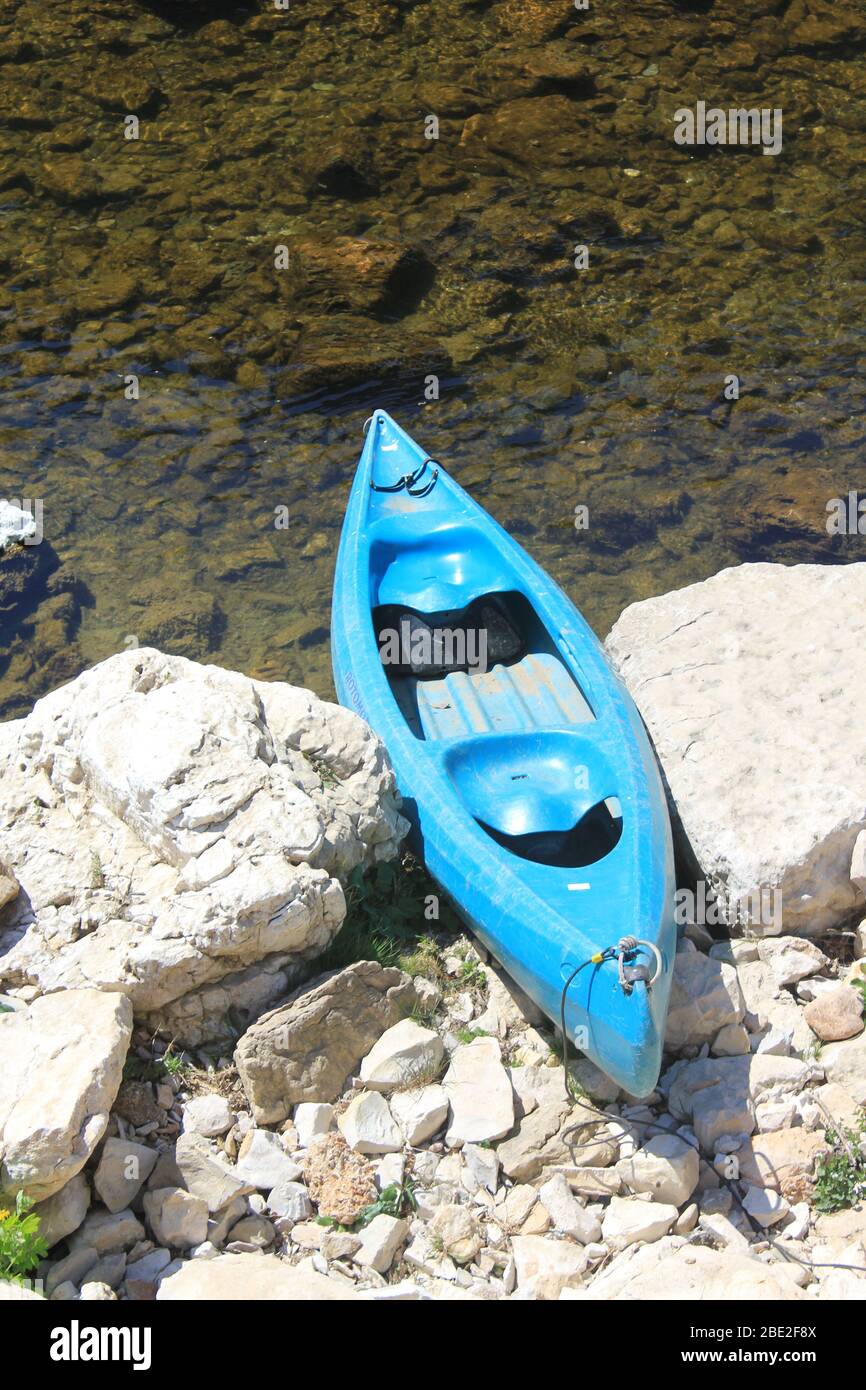 Blue canoe, beached Stock Photo