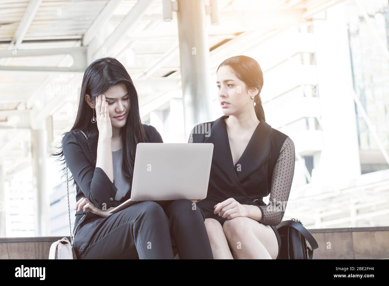 business woman talking and working on laptop and serious about work outside Stock Photo