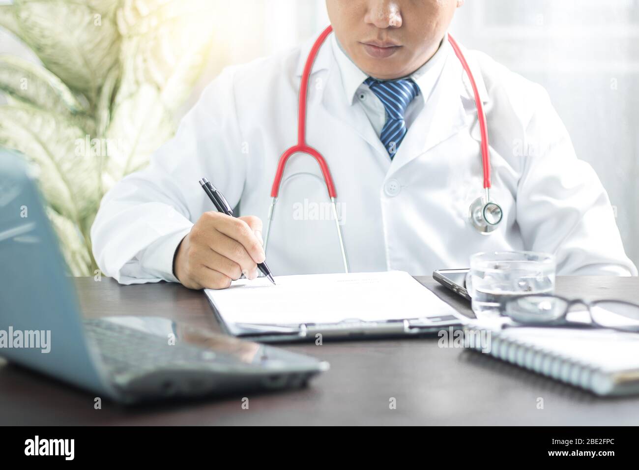 Male nurse writing on clipboard hi-res stock photography and images - Alamy
